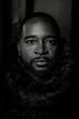 © Kristen Blush - Close up lack and white photo of a black man in a dark atmosphere