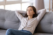 © fizkes - Young calm woman chilling relaxing leaning on comfortable sofa napping on couch in living room resting having healthy quiet nap, breathing fresh air, no stress free weekend at home, peace of mind