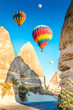 © Hakan Tanak - Colorful hot air balloons flying over at fairy chimneys in Nevsehir, Goreme, Cappadocia Turkey. Hot air balloon flight at spectacular Cappadocia Turkey.