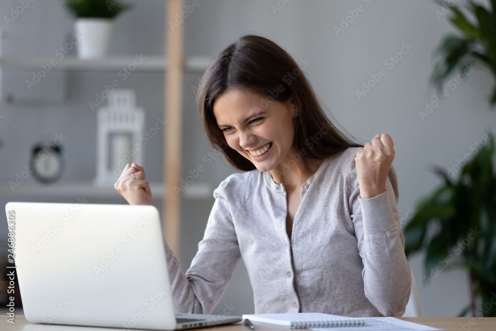 Excited ecstatic teen girl winner celebrating victory success reading admission email with good exam results, happy student rejoicing online win got new job opportunity looking at laptop computer