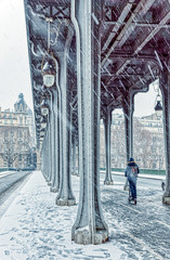 Snowfall over a scooter on Pont de Bir-Hakeim, also known as viaduc de Passy - a bridge that cross the Seine River in Paris, France