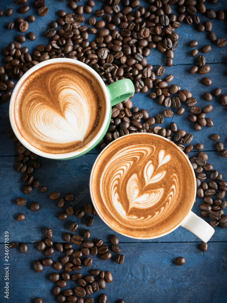 Hot coffee in a cup with foam milk beautiful latte art and coffee beans on  blue wooden table background. Cappuccino or latte with froth foam, drinks  concept. Stock Photo | Adobe Stock