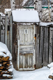 Fototapeta Na ścianę - White old door in a wooden fence 2