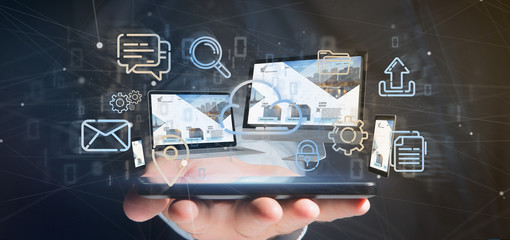Wall Mural - Businessman holding a Devices connected to a cloud multimedia network 3d rendering