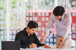© Songsak C - Image of engineer meeting for architectural project working with partner and engineering tools on workplace.