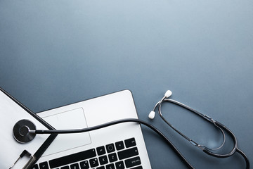 modern medical technology and sofware advances concept. doctor's working table with stethoscope acou