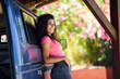 © javiindy - Young woman in a camper van in a beautiful camping with pink flowers