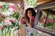 © javiindy - Young woman in a camper van in a beautiful camping with pink flowers