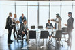 © alfa27 - multiracial business people discussing negotation in the office with panorama window. commercial conversation