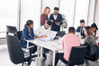© alfa27 - Coworking team meeting. Group of mixed-race diverse co-workers discussing new startup project in modern office with panoramic windows.
