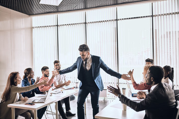 Wall Mural - excited bearded mman giving high five to his colleagues. good job.