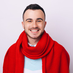 Wall Mural - Portrait of young handsome hipster man with red scarf smiling laughing looking at camera