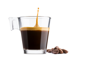 Black coffee in glass cup with coffee beans and  jumping drop on white background