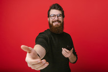 Portrait Of Cheerful Bearded Man .stretches His Hand, Inviting Handsome