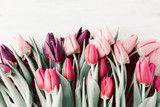 Spring tulips lying on white wooden table background