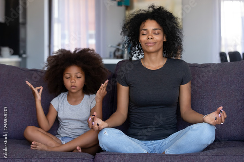 Mindful African Mom With Cute Funny Kid Daughter Doing Yoga