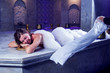 © Aleksej - Young woman relaxing in hammam or turkish bath.