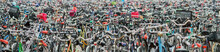 Panoramic View Of A Huge Crowded Public Bicycle Parking With Many Children Seats.