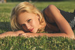 © Sergios - Young beautiful blonde woman relaxing on a green meadow