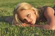 © Sergios - Young beautiful blonde woman relaxing on a green meadow