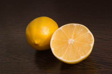 Two halves of lemon on a dark background