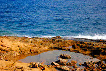 Breaking Waves At The Red Rocky Coast Of Sissi On Crete In Greece