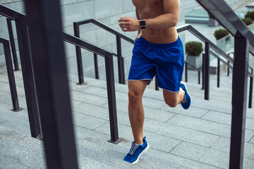 Wall Mural - Bare-chested man with attractive body jogging outdoor