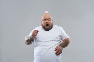 Impressed man with marshmallow souffle on his head opening his mouth