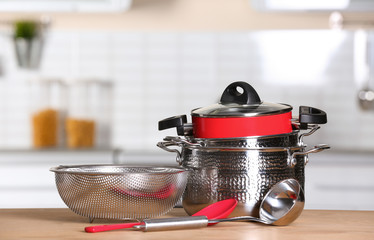 Wall Mural - Set of clean cookware and utensils on table in kitchen