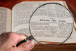© ronniechua - Magnifying Glass on Famous Bible Chapter of Job, a King James Bible which is Public Domain.