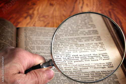 Magnifying Glass on Famous Bible Verse John 3:16, a King James Bible which is Public Domain.