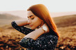© Strelciuc - Close up portrait of young lovely woman looking away dreaming with closed eyes with hand on her neck against sunset.