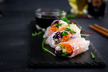 Wall Mural - Vegetarian vietnamese spring rolls with spicy sauce, carrot, cucumber, red cabbage and rice noodle. Vegan food. Tasty meal.  Copy space