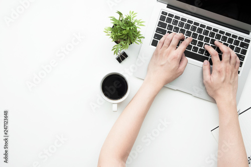 Cuadros en Lienzo Young man is typing on laptop keyboard over white office desk