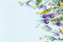 Flowers Composition. Yellow And Purple Flowers On Pastel Blue Background. Spring, Easter Concept. Flat Lay, Top View, Copy Space
