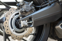 Closeup Detail Of Sport Racing Motorcycle Wheel And ABS Brakes System With Aluminium Swingarm 220 Mm Rear Disc 1 Piston Caliper Stopping Power ABS Fitted As Standard.