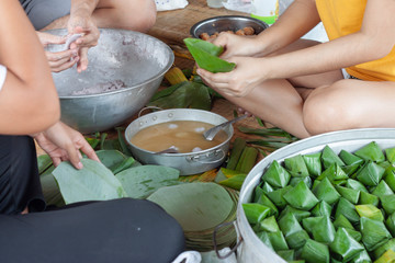 People help to make stuffed dough pyramid dessert for god worship. On the Chinese New Year.