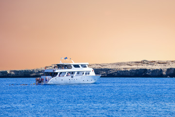 Sticker - Yacht in blue lagoon on sunset. Tourist boat in Cyprus. Vacation, holiday background or concept.