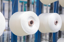 Group Of Bobbin Thread Cones On A Warping Machine In A Textile Mill. Yarn Ball Making In A Textile Factory. Textile Industry - Yarn Spools On Spinning Machine In A Textile Factory