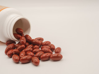 Vitamins and supplements with a bottle on white background