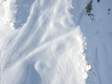 Aerial View Of Ski Tracks In Snow. Backcountry Skiing In Powder, Leaving Trails In Snow.