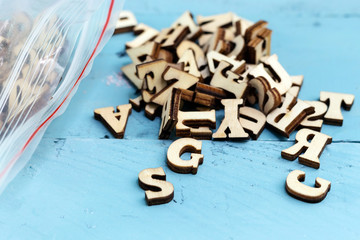 Light brown wooden basic bold font style full alphabet capital letter on realistic wood background with plastic bag