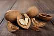 Walnut with heart shaped kernel and whole walnuts on wooden backround.