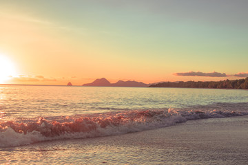 Wave on the beach at sunset on Martinique