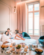 couple having breakfast in bed, men and woman honeymoon Paris