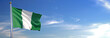 Flag of Nigeria rise waving to the wind with sky in the background