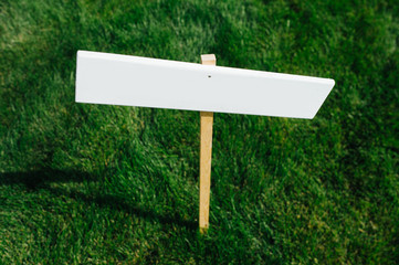 Short trimmed grass with white empty sign