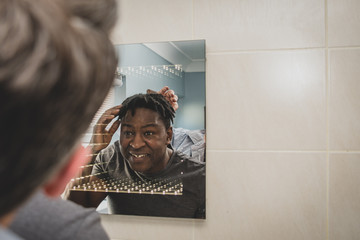 Wall Mural - A gay couple together in front of the bathroom mirror.