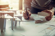 © Chaosamran_Studio - architect design working drawing sketch plans blueprints and making architectural construction model in architect studio