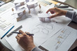 © Chaosamran_Studio - architect design working drawing sketch plans blueprints and making architectural construction model in architect studio